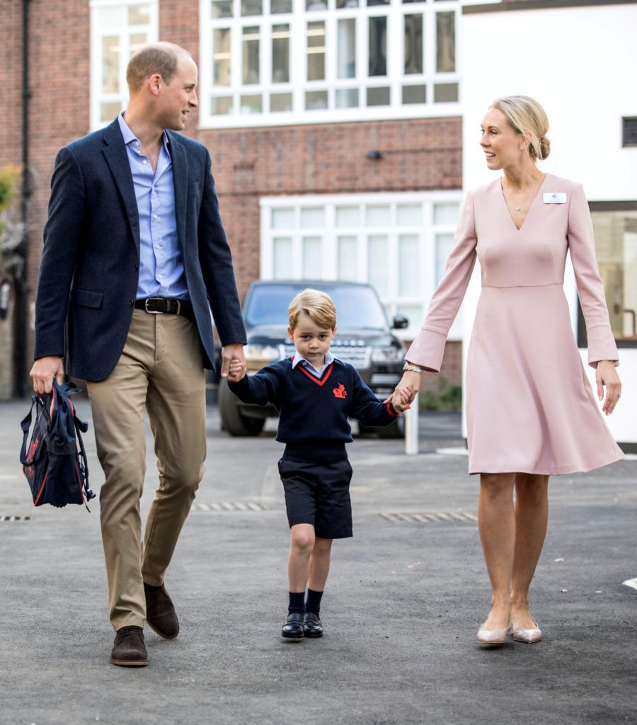 Helen Haslem, head of the lower school and Britain's Prince William hold Prince George's hands as he arrives for his first day of school at Thomas's school in Battersea, London